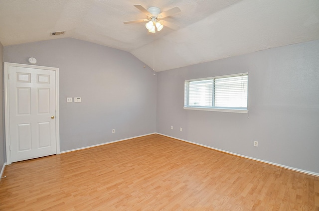 bonus room with vaulted ceiling, a textured ceiling, ceiling fan, and light wood-type flooring