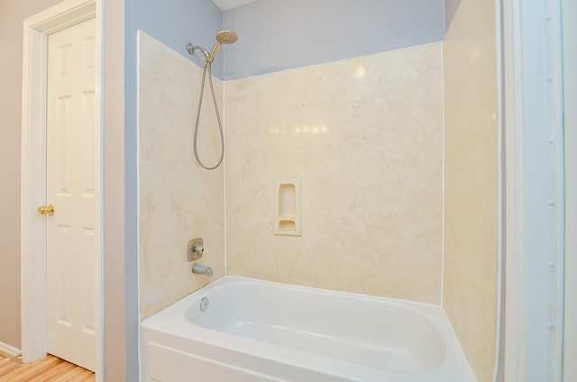 bathroom with shower / bath combination and hardwood / wood-style floors