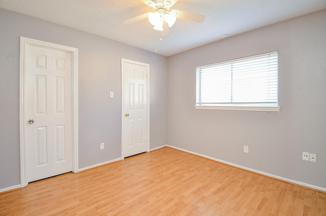 unfurnished bedroom featuring ceiling fan and light hardwood / wood-style flooring