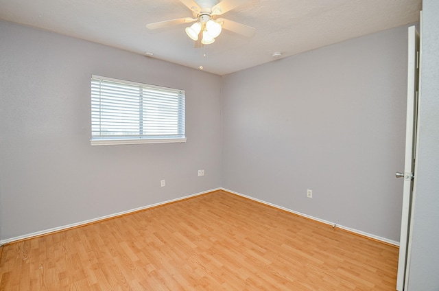 spare room featuring ceiling fan and light wood-type flooring