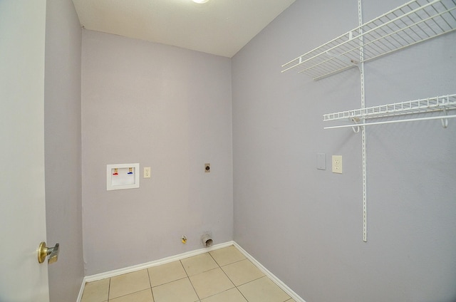 washroom featuring washer hookup, electric dryer hookup, and light tile patterned flooring