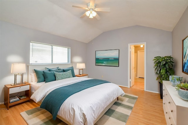 bedroom featuring ceiling fan, vaulted ceiling, and light hardwood / wood-style flooring