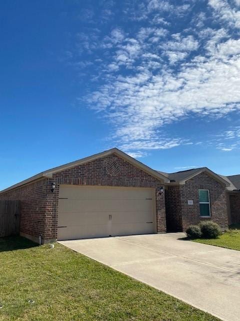 single story home with a garage and a front lawn