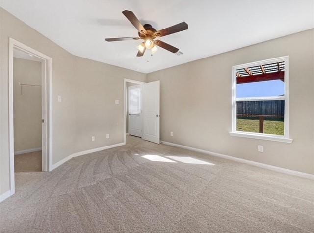 carpeted spare room with ceiling fan