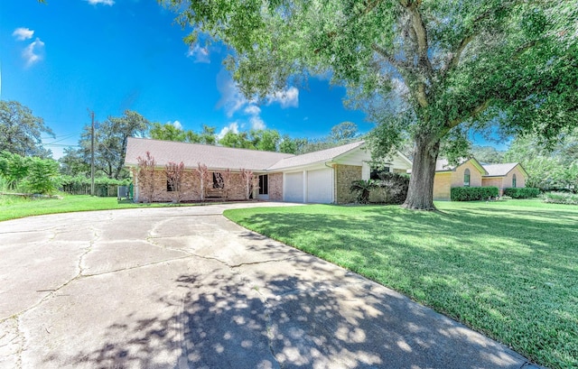 single story home featuring a garage and a front lawn