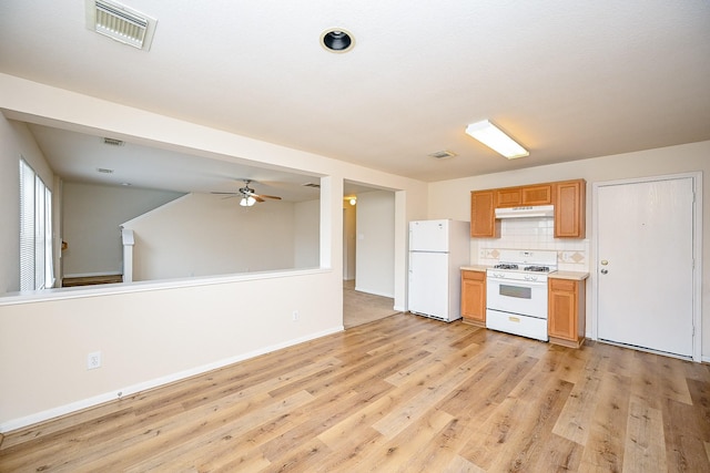 kitchen with tasteful backsplash, ceiling fan, light wood-type flooring, and white appliances