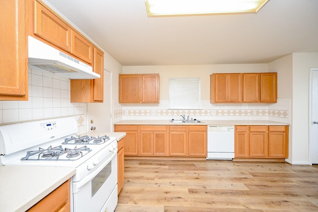 kitchen featuring tasteful backsplash, sink, white appliances, and light wood-type flooring