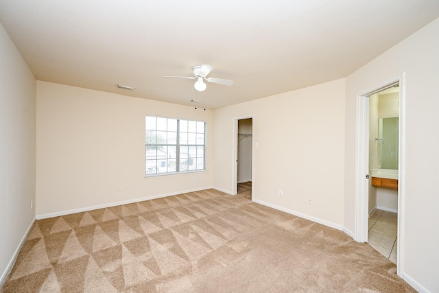 carpeted empty room featuring ceiling fan