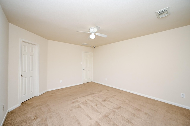 empty room with light colored carpet and ceiling fan