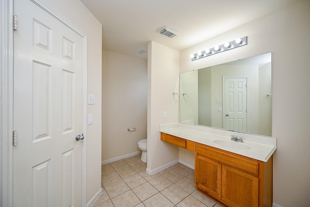 bathroom with vanity, tile patterned floors, and toilet