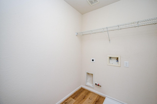 laundry area featuring gas dryer hookup, hardwood / wood-style flooring, hookup for a washing machine, and electric dryer hookup