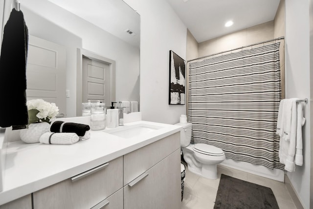 bathroom featuring a shower with curtain, tile patterned floors, vanity, and toilet