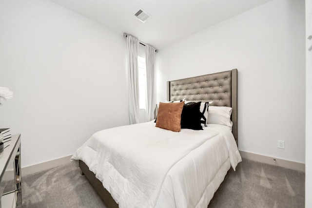 carpeted bedroom featuring visible vents and baseboards