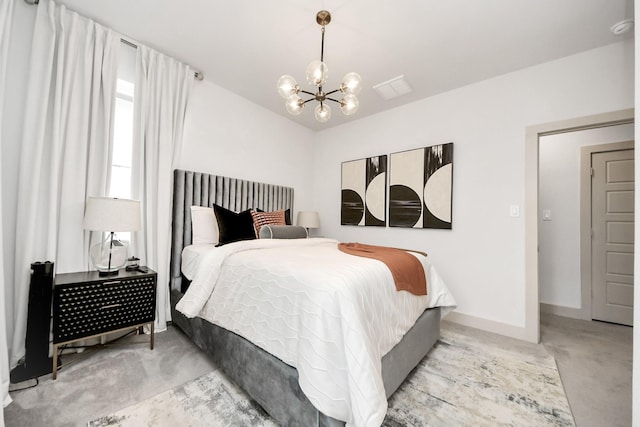 carpeted bedroom with a chandelier