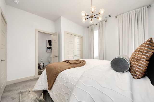 carpeted bedroom featuring visible vents, baseboards, a notable chandelier, and a closet