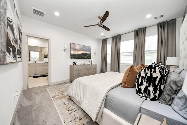 carpeted bedroom with ceiling fan and connected bathroom