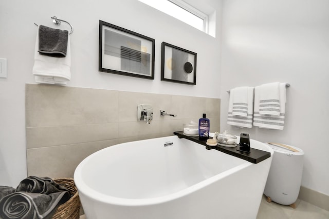 bathroom featuring a soaking tub and tile walls