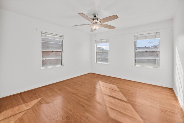 spare room featuring ceiling fan and light hardwood / wood-style flooring