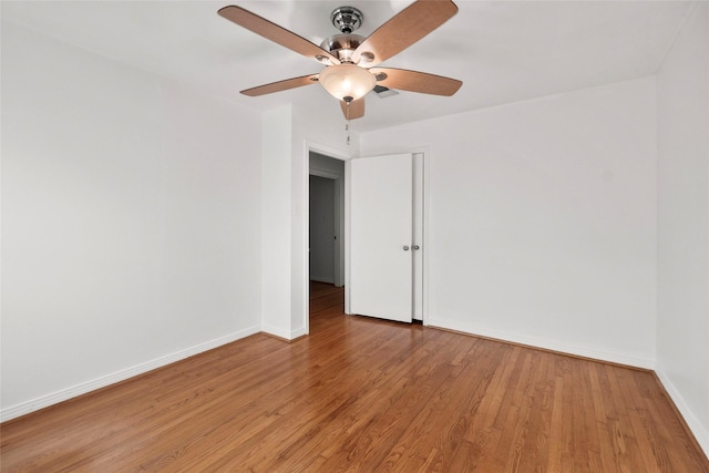 empty room featuring ceiling fan and light hardwood / wood-style flooring