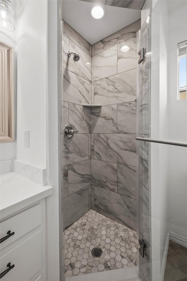 bathroom with a shower with shower door