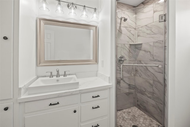 bathroom with a shower with door and vanity