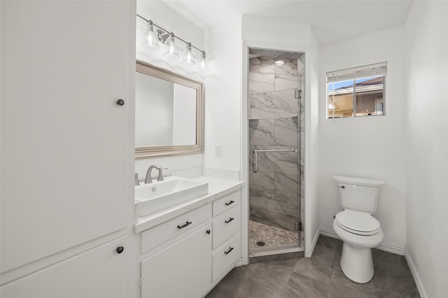 bathroom with vanity, a shower with door, and toilet