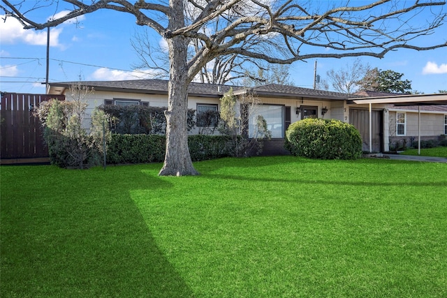 ranch-style home featuring a front yard