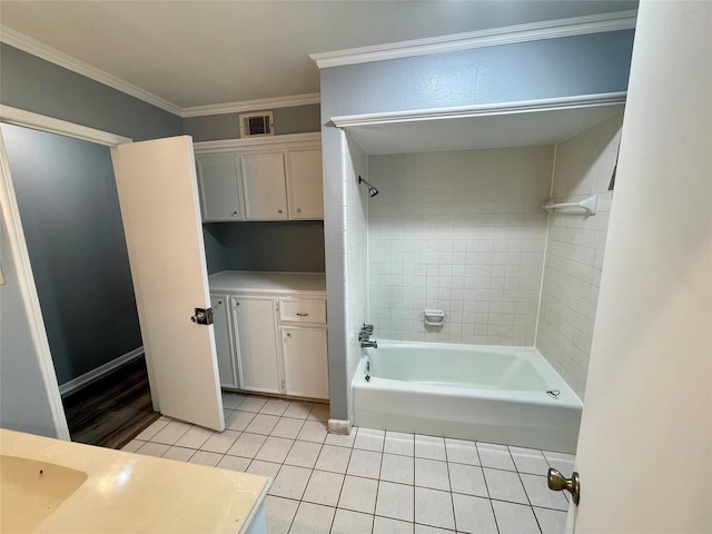 bathroom with tiled shower / bath, ornamental molding, tile patterned floors, and vanity