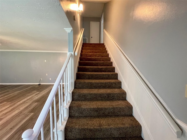 stairs with hardwood / wood-style floors