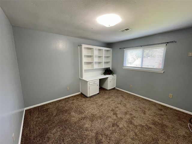 unfurnished office with carpet flooring and a textured ceiling