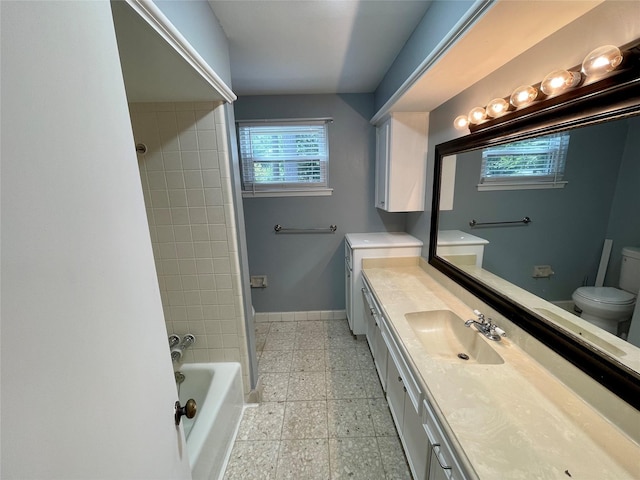 full bathroom with vanity, toilet, and tiled shower / bath