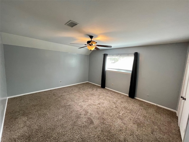 carpeted empty room featuring ceiling fan and lofted ceiling