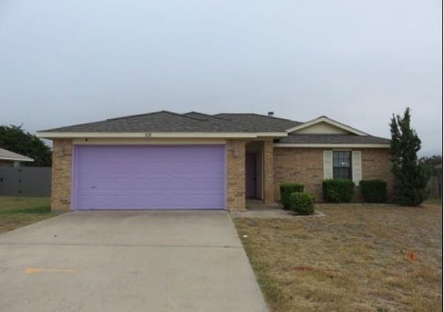 ranch-style home featuring a garage