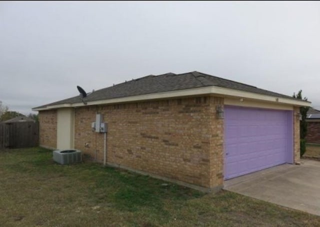 view of property exterior featuring a garage and a lawn