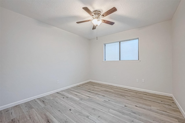 spare room with ceiling fan, light hardwood / wood-style floors, and a textured ceiling