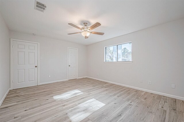 empty room featuring ceiling fan and light hardwood / wood-style flooring