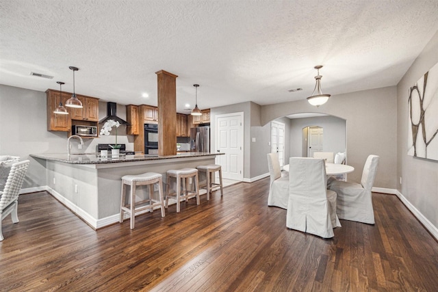 dining room featuring dark hardwood / wood-style flooring, sink, and a textured ceiling