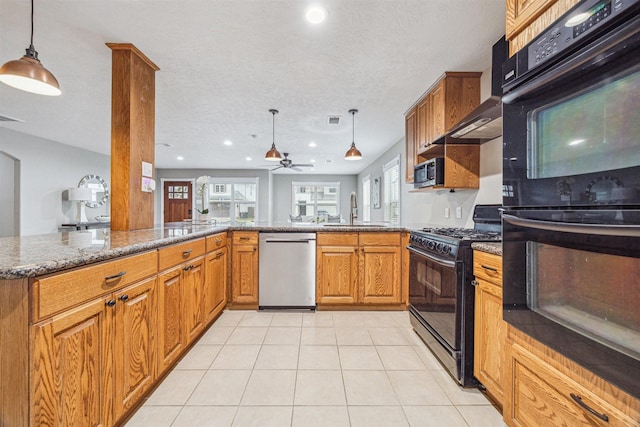 kitchen featuring sink, hanging light fixtures, kitchen peninsula, dark stone counters, and black appliances