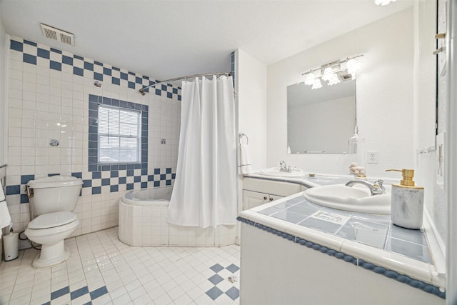 full bathroom featuring tile patterned flooring, vanity, shower / bath combo, and toilet