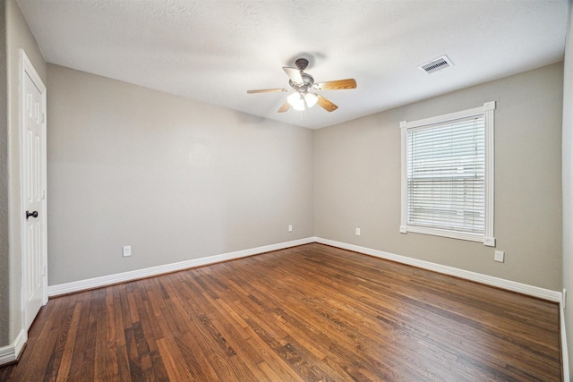 empty room featuring dark wood-type flooring and ceiling fan