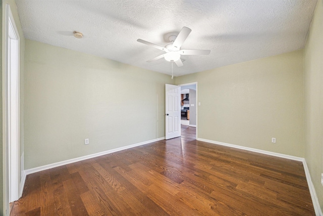 spare room featuring dark hardwood / wood-style floors, a textured ceiling, and ceiling fan