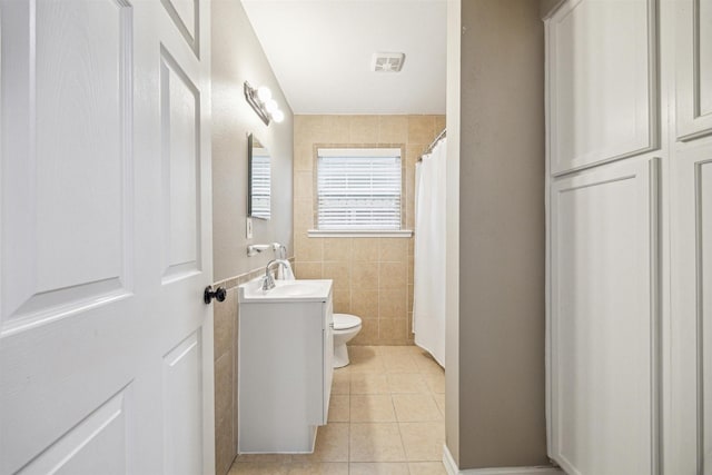 bathroom with tile walls, tile patterned flooring, vanity, toilet, and a shower with shower curtain