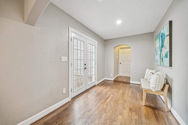 foyer entrance featuring french doors and light hardwood / wood-style floors