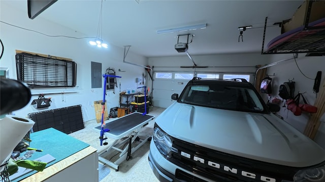 garage featuring a garage door opener and electric panel