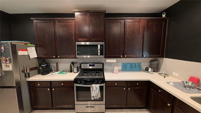 kitchen featuring dark brown cabinets, stainless steel appliances, and decorative backsplash