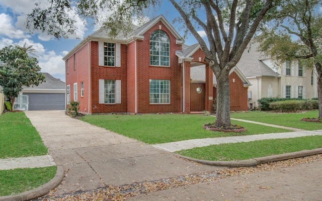 view of front of house featuring brick siding, a front lawn, an outdoor structure, and a detached garage