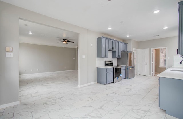 kitchen featuring marble finish floor, appliances with stainless steel finishes, light countertops, and open floor plan