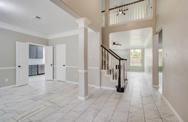 entryway with baseboards, visible vents, stairway, marble finish floor, and ornate columns