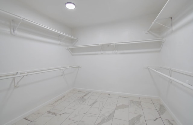 spacious closet featuring marble finish floor