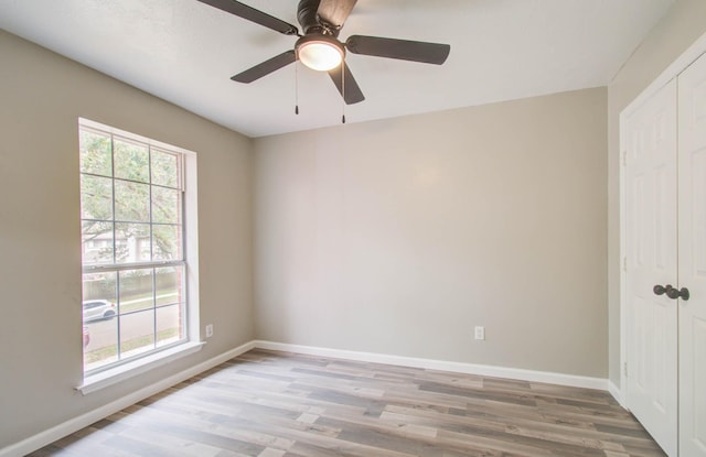 empty room with light wood-style floors and baseboards